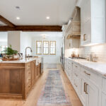 Another view of the hickory island and white cabinets.