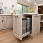 This photo shows the pull-out garbage can storage under the island.