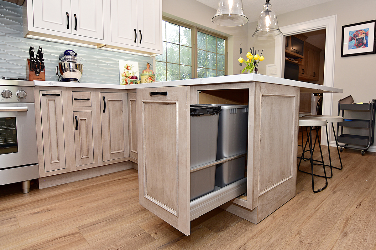 This photo shows the pull-out garbage can storage under the island.
