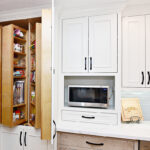 The ceiling-to-floor pantry has cabinet shelves that slide and turn out.