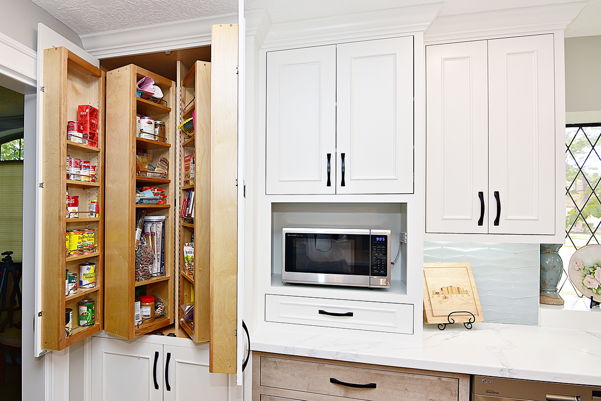 The ceiling-to-floor pantry has cabinet shelves that slide and turn out.