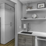 brushed gray kitchen cabinetry under stainless steel sink.