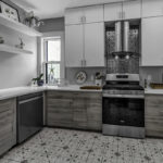 small city kitchen with gray upper cabinetry. Stone countertops sit on gray brushed wood cabinetry.