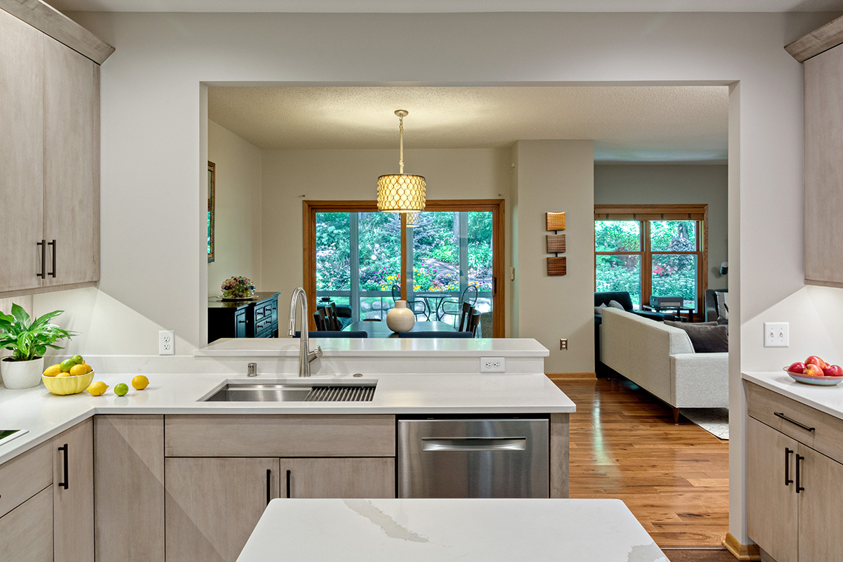 a light natural colored kitchen with white counter tops.
