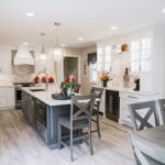 A shot of the whole kitchen with the island in the middle of the room.