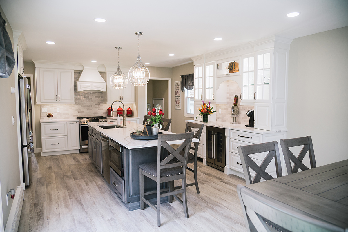 A shot of the whole kitchen with the island in the middle of the room.