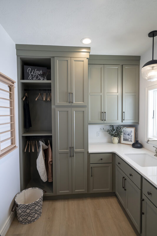 gray cabinetry in mudroom, with white countertops.