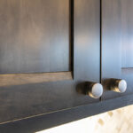 The cabinet faces are flush and the hardware of these cabinets is a sleek round hold that is not in-cut.