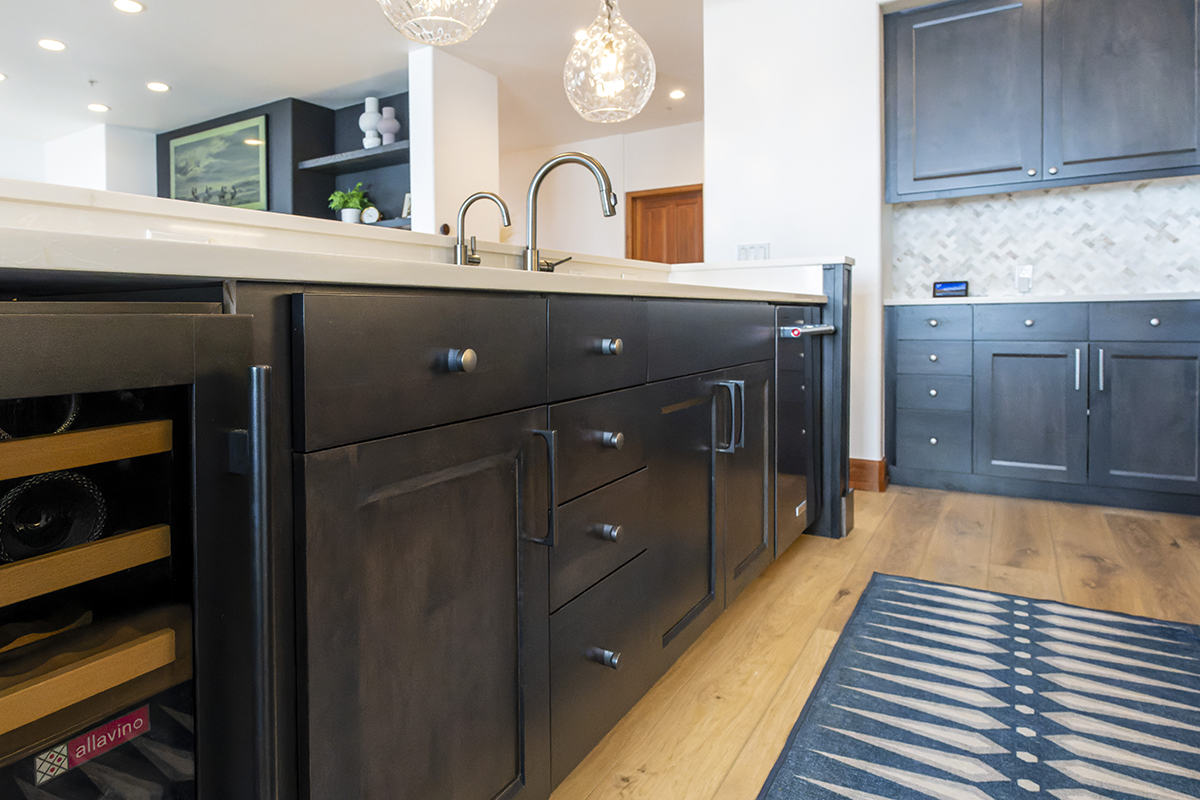 A view of the cabinet doors and drawers with brushed grey hardware on the island.