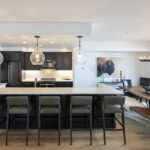 A view of the kitchen and the large dining room table.