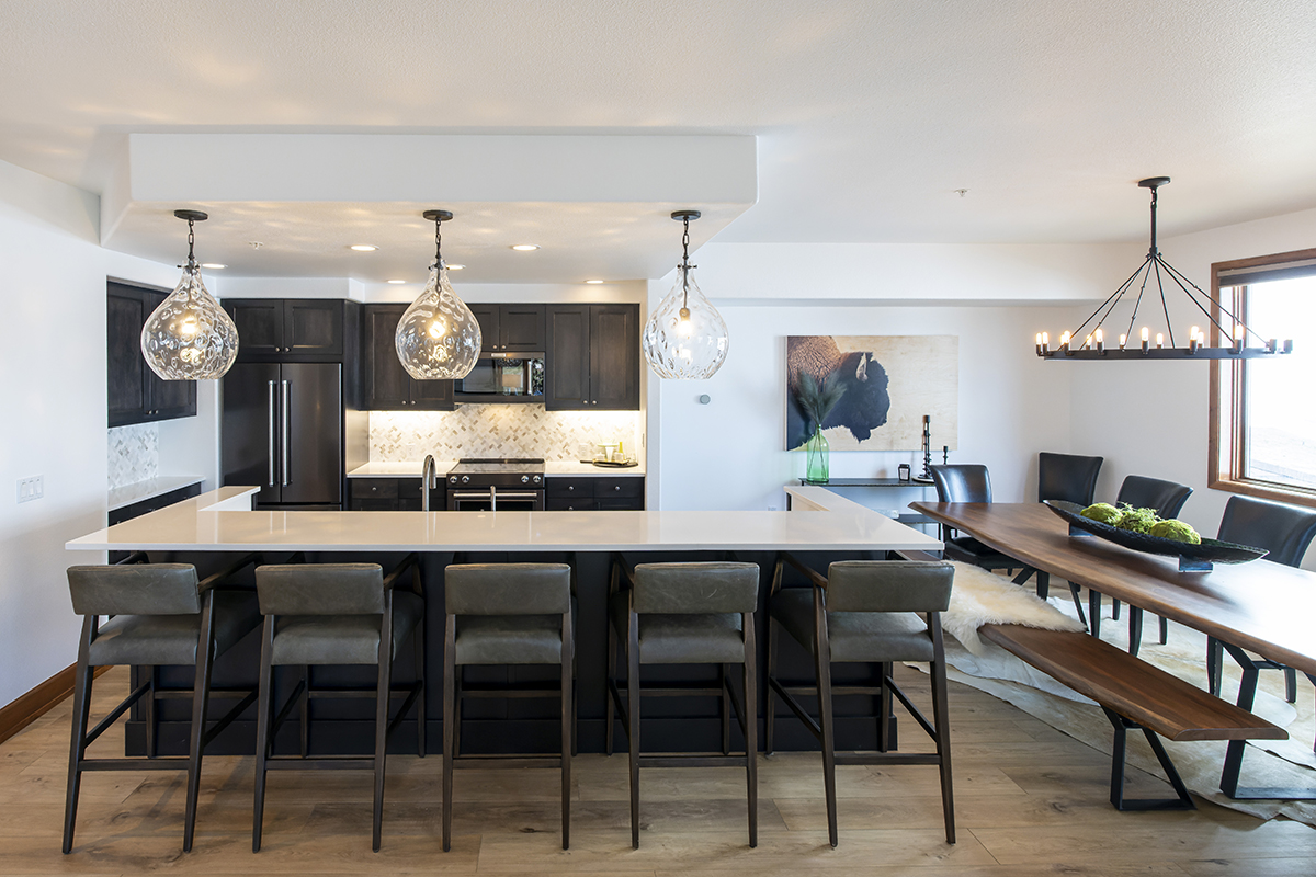 A view of the kitchen and the large dining room table.
