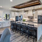 all white modern kitchen, white kitchen cabinetry and vanity, open floor plan