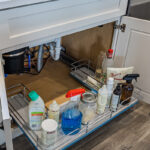 kitchen sink drawer filled with cleaning supplies