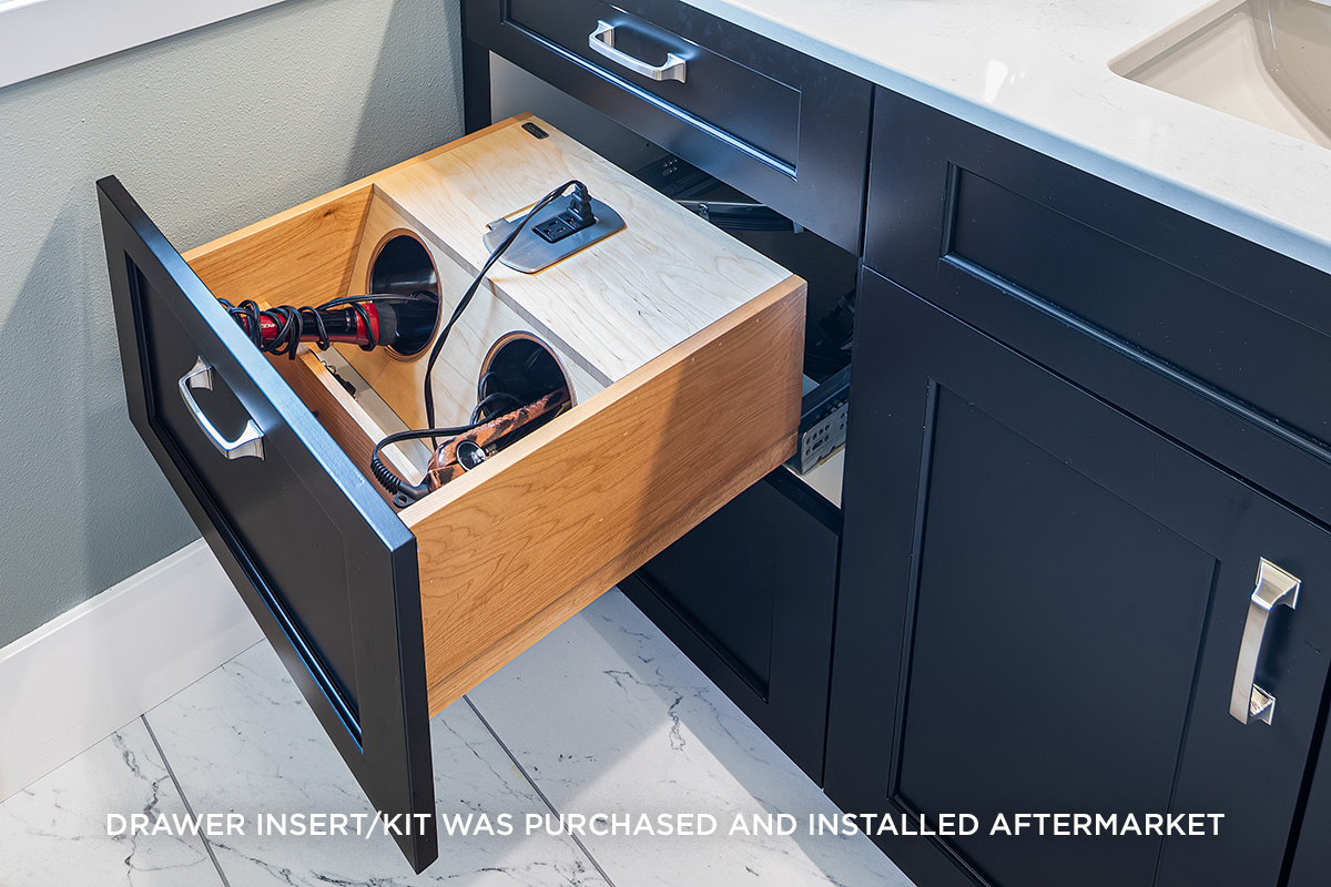 black bathroom cabinetry with curling iron and hair dryer specific drawer