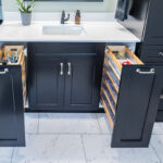 black bathroom cabinets with organized bathroom supply drawers