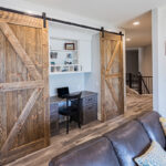 built in desk that can be closed off with sliding barn doors.