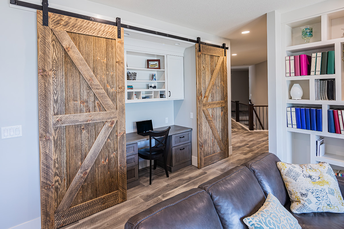 built in desk that can be closed off with sliding barn doors.