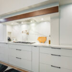 Open Space White Kitchen with accent green wall