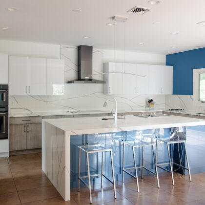 Stained and white acrylic kitchen perimeter with blue acrylic surface island cabinets