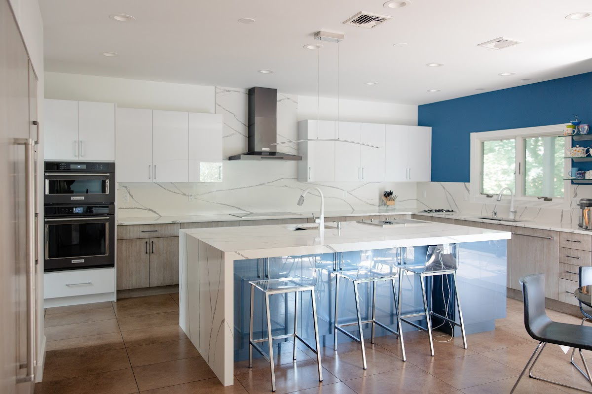 Stained and white acrylic kitchen perimeter with blue acrylic surface island cabinets