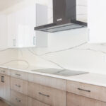 Stained kitchen cabinets with white acrylic wall cabinets