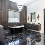 Stained master bath with floating vanities and free standing tub