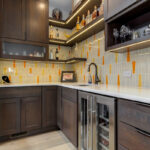 Stained kitchen cabinets with island.