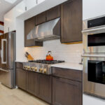 Stained kitchen cabinets with island.