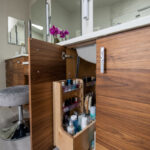 Bathroom storage cabinet with a pullout organization accessory