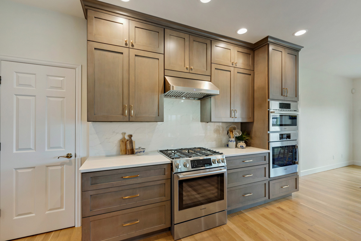 Stained kitchen cabinets with stainless steel appliances