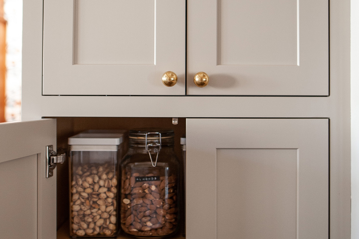 Painted wall cabinet with food and appliance storage