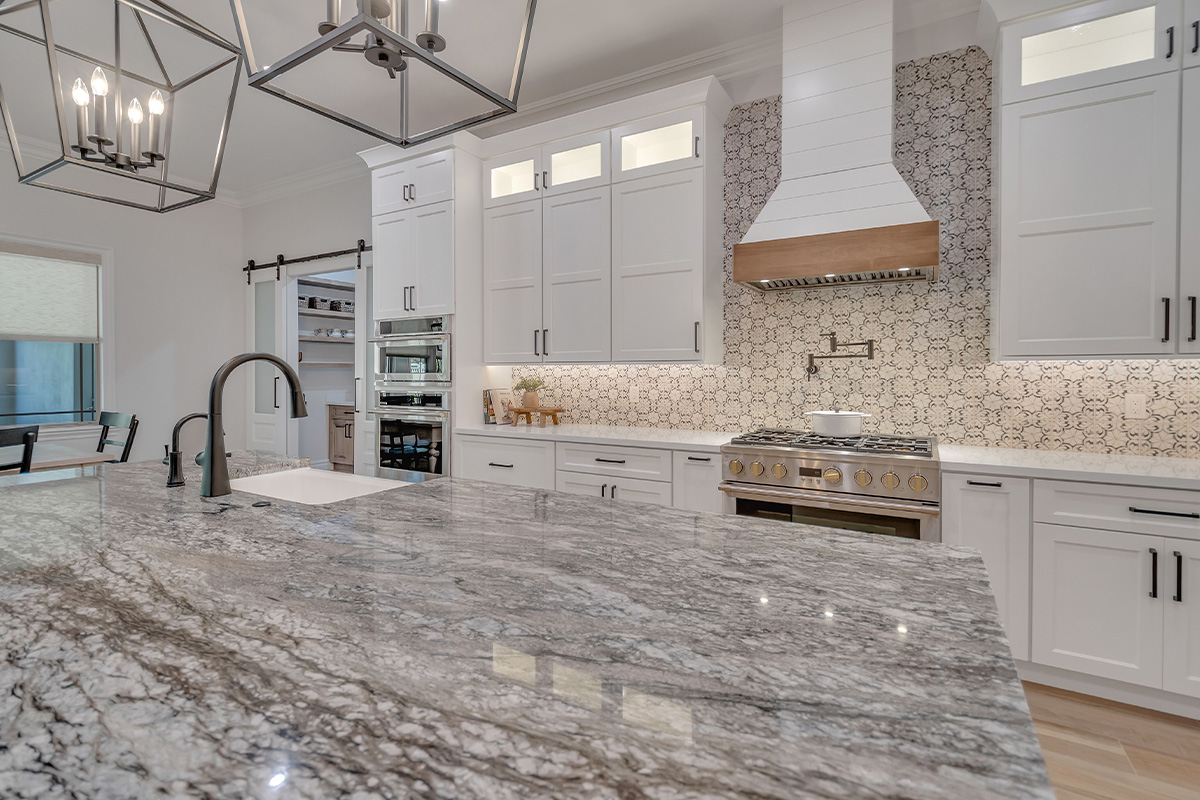 White kitchen with stained accent apron on hood.