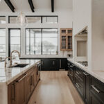 Painted and stained large open kitchen with beams on ceiling