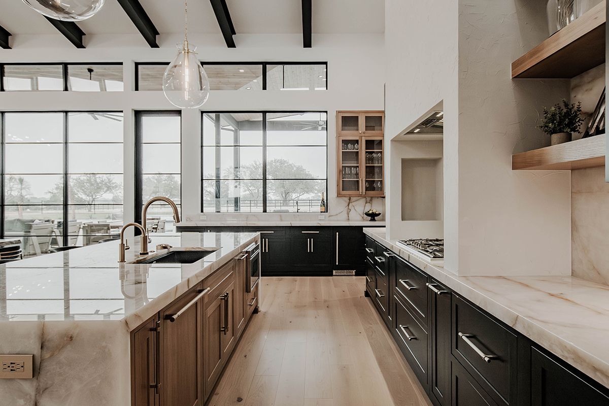 Painted and stained large open kitchen with beams on ceiling