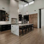 Painted and stained large open kitchen with beams on ceiling