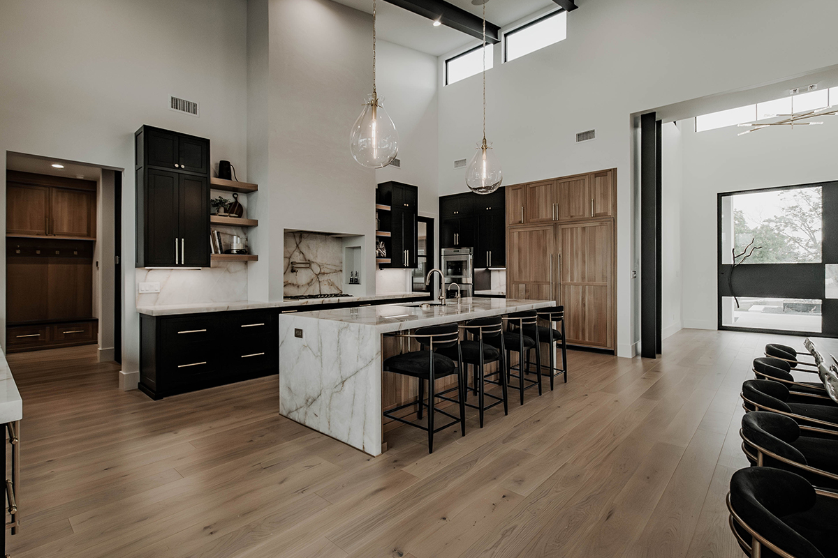 Painted and stained large open kitchen with beams on ceiling