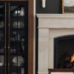 black painted cabinet next to a fireplace