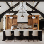 Large open kitchen space with wood beams and stained and painted cabinets