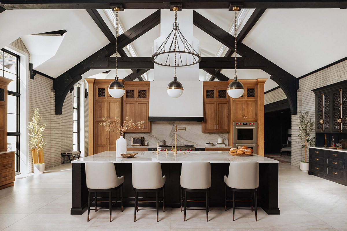 Large open kitchen space with wood beams and stained and painted cabinets