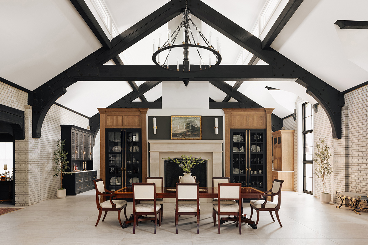 Large open kitchen space with wood beams and stained and painted cabinets