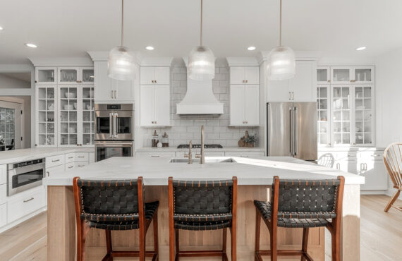 White kitchen cabinets with stained island