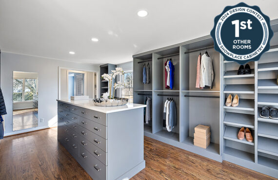 Painted walk-in closet cabinets with hanging closes and a center island for additional storage