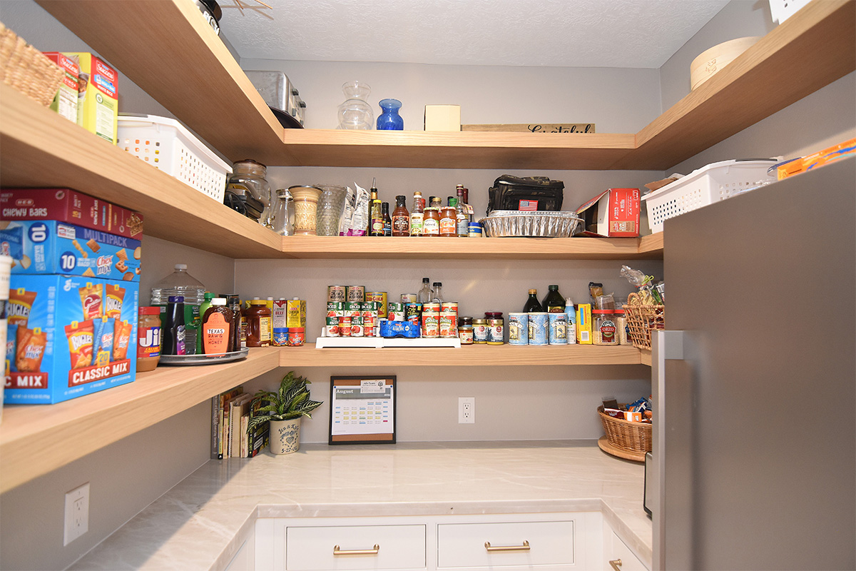 Pantry with stained floating shelves and painted cabinets below