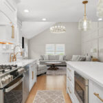 White painted kitchen with island and stainless steel stove