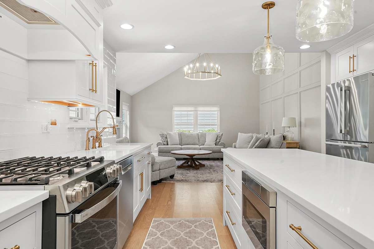 White painted kitchen with island and stainless steel stove