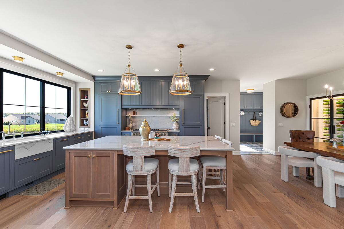 Kitchen with painted perimeter cabinets and stained island cabinets