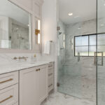 Painted bathroom vanity and shower with clear glass walls