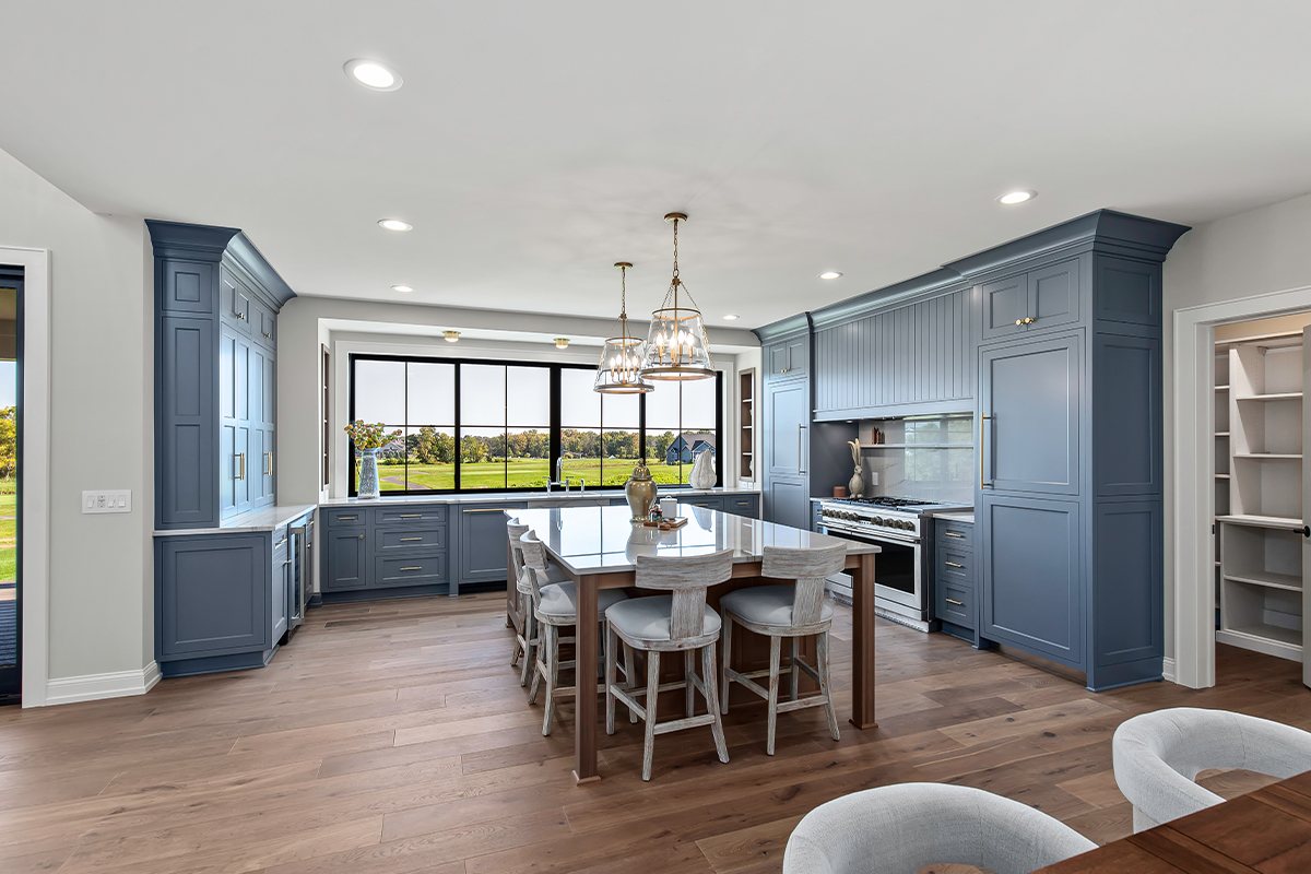 Kitchen with painted perimeter cabinets and stained island cabinets