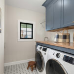 Painted laundry room cabinets with washer/dryer