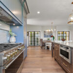 Kitchen with painted perimeter cabinets and stained island cabinets